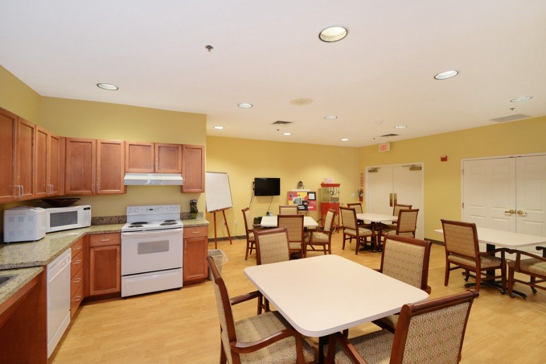 Interior view of Tempe senior living community featuring dining room, kitchen appliances, and decor.