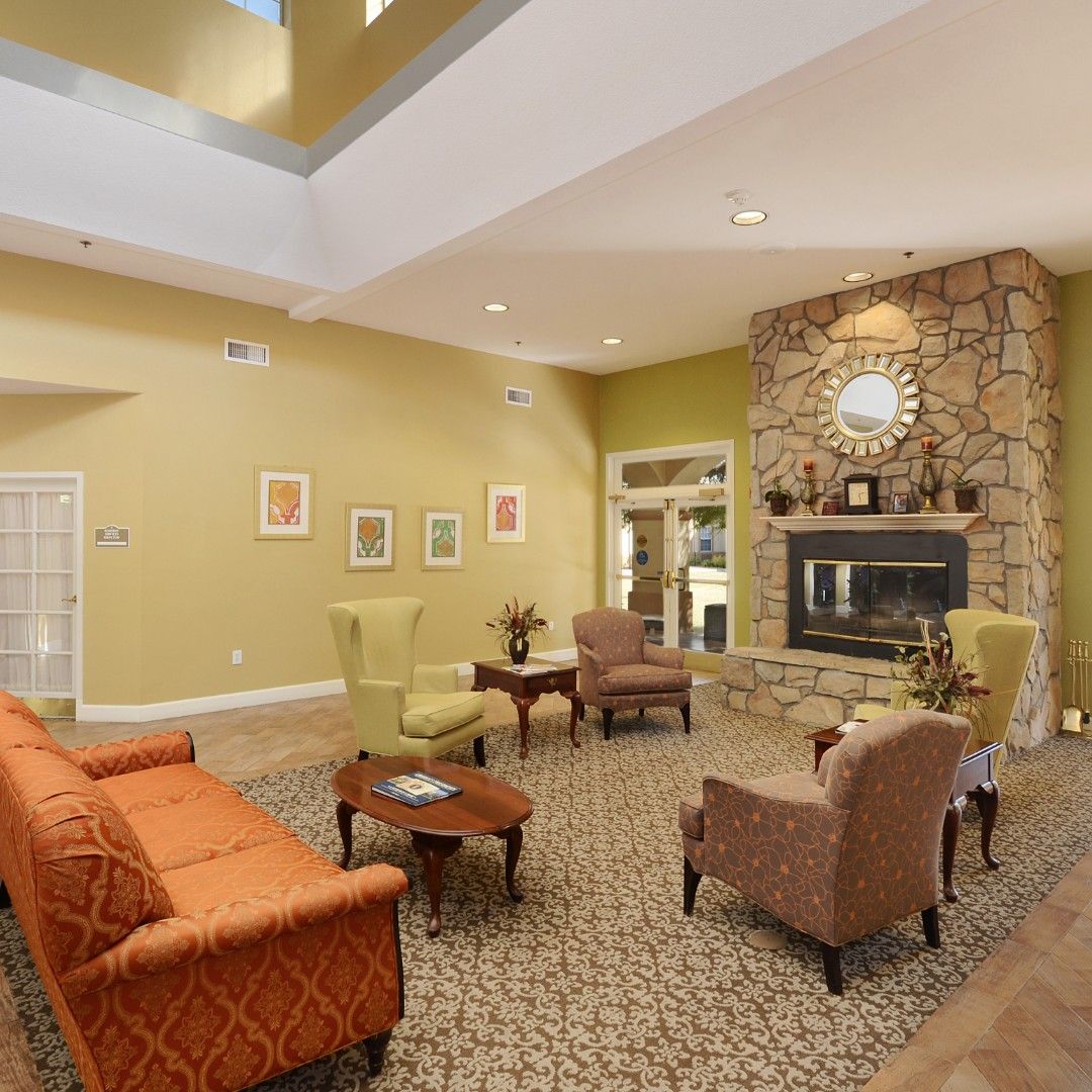Senior living community room in Tempe with elegant decor, furniture, art, and fireplace.