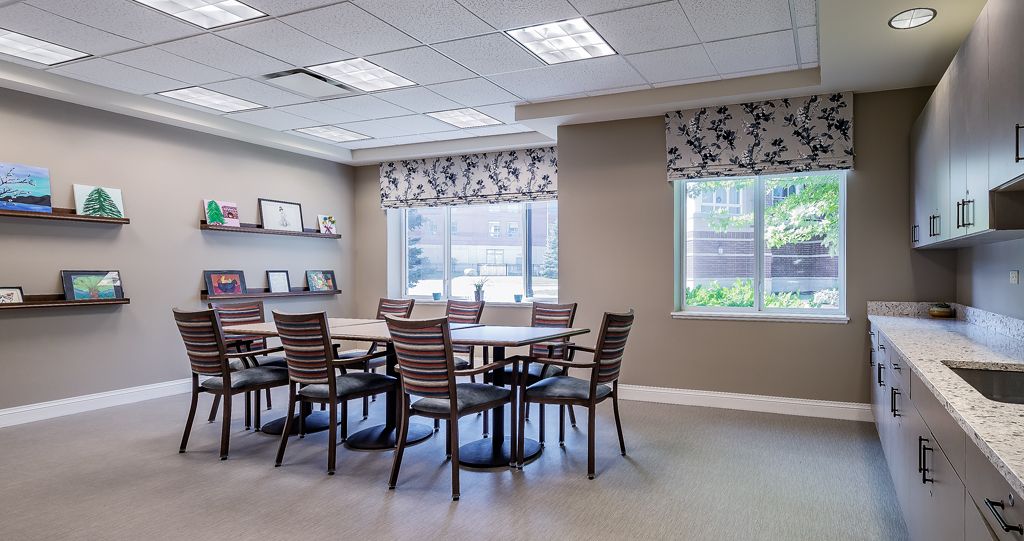 Interior view of Autumn Green at Wright Campus senior living community featuring dining room and kitchen.