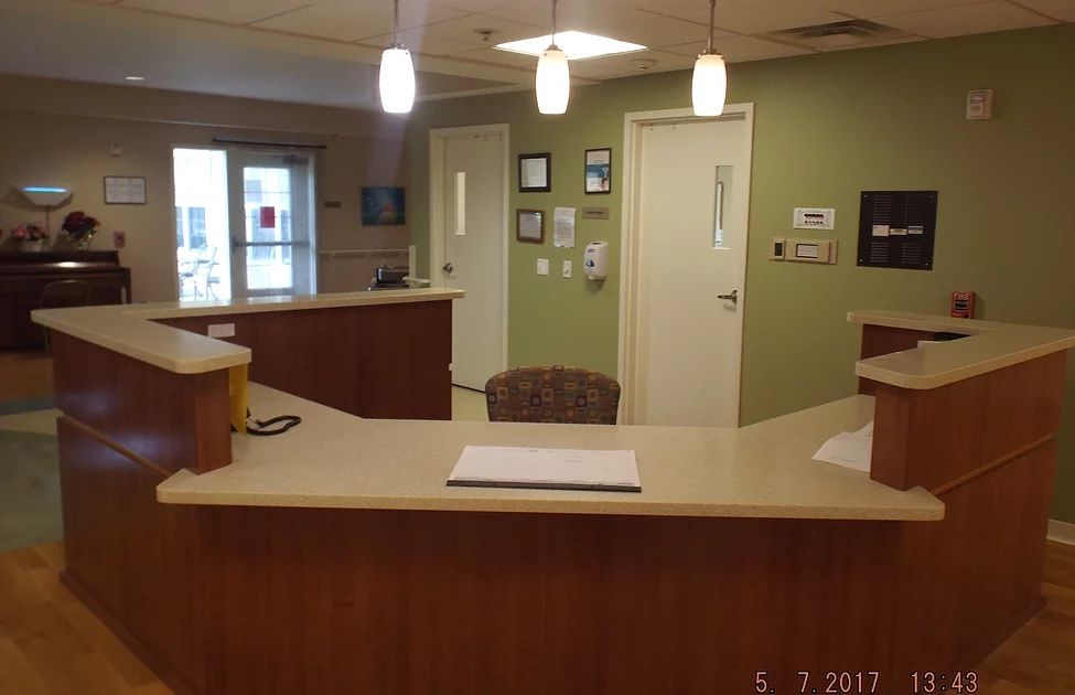 Interior view of Christian Care Home featuring wooden furniture, reception desk, and clinic.