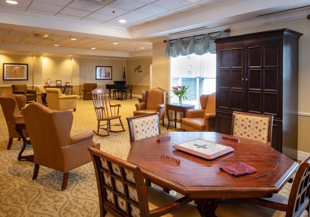 Interior view of The Linden at Dedham senior living community featuring dining room, lounge, and art decor.