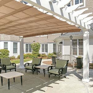 Senior living community, Hoffman Summerwood, featuring housing with patios, pergolas, and outdoor furniture.