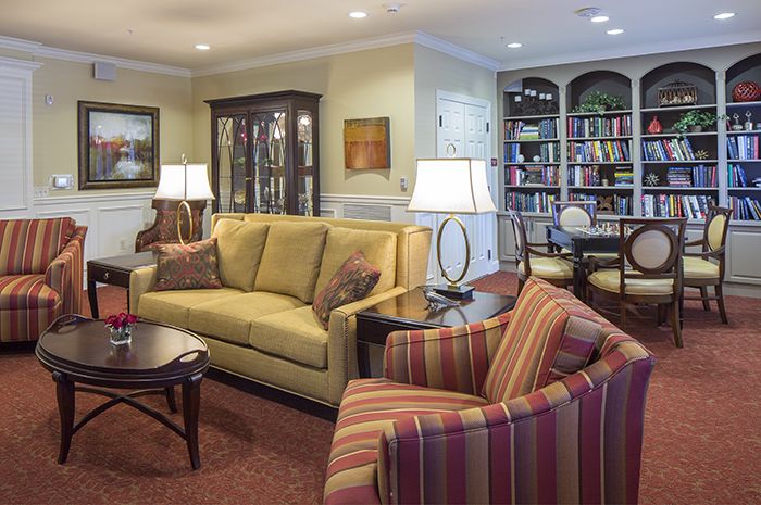 Interior design of Brightview Fallsgrove senior living room with furniture, home decor, and library.