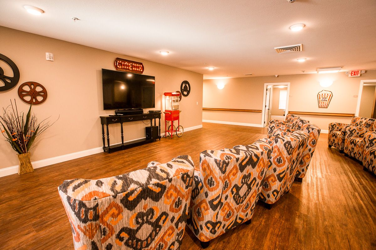 Interior of a senior living community room with modern electronics, hardwood flooring, and home decor.