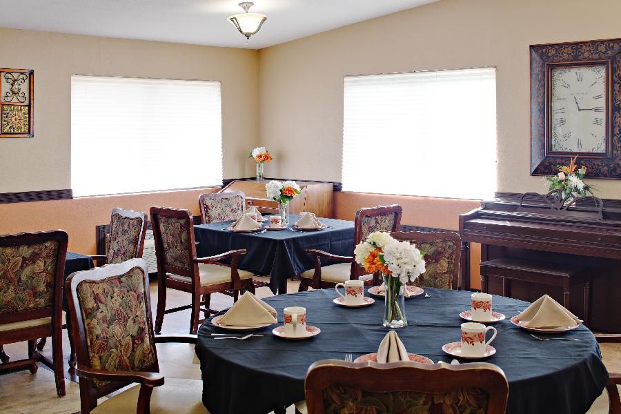 Senior living community, Willow Ridge Center, featuring elegant dining room with piano and floral decor.