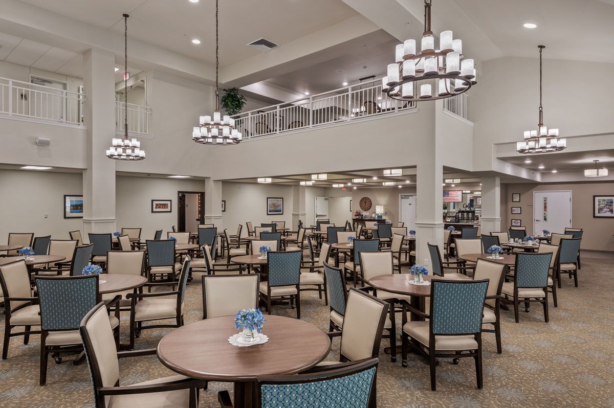 Indoor view of Wilshire Estates Retirement Living featuring dining area, lounge, and architecture.