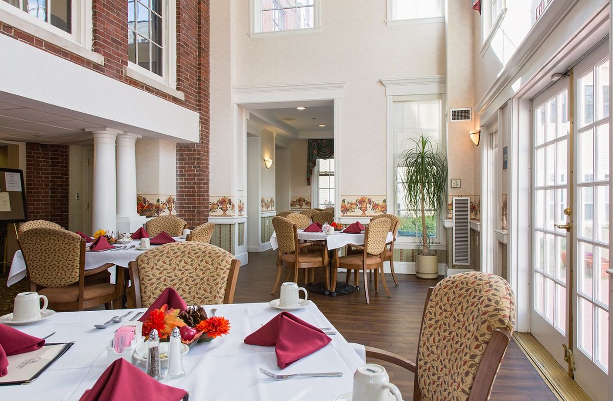 Interior view of the Residence at Paine Estate senior living community featuring dining and living areas.