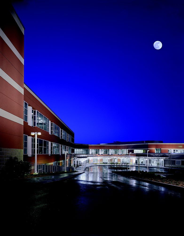 San Mateo Medical Center at night, featuring urban architecture, waterfront scenery, and moonlit sky.