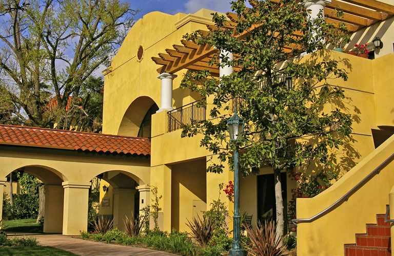 Senior living community Hollenbeck Palms featuring villa-style housing with porch, patio, and plants.