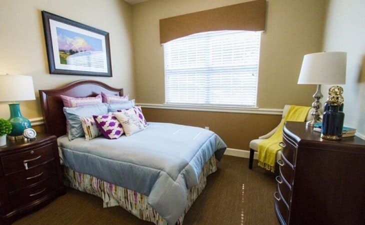 Bedroom interior at Bader House, a senior living community in Georgetown, featuring art and home decor.
