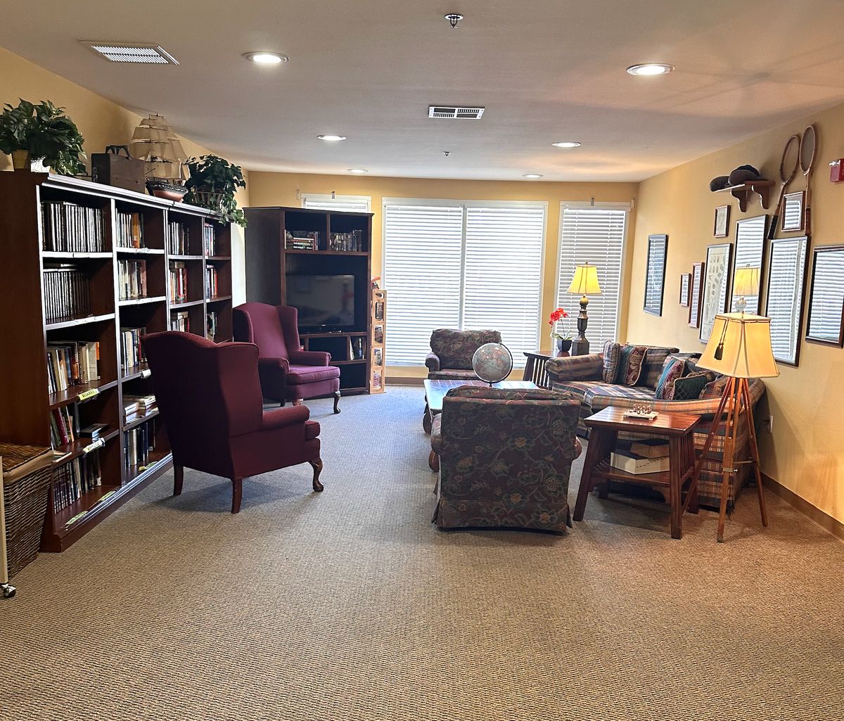 Interior view of Leisure Vale Assisted Living with modern decor, furniture, and a library.