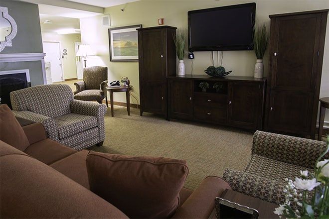 Interior view of Brookdale Dowlen Oaks senior living room with modern furniture, electronics, and decor.