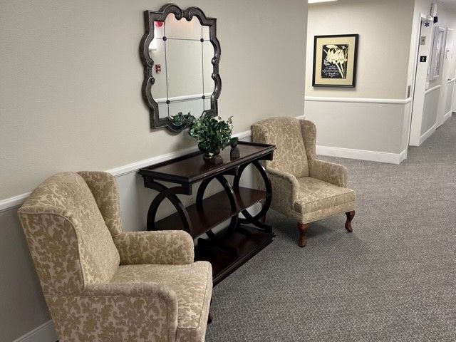 Interior view of Sparr Heights Estates Senior Living with furniture, art, and plants.