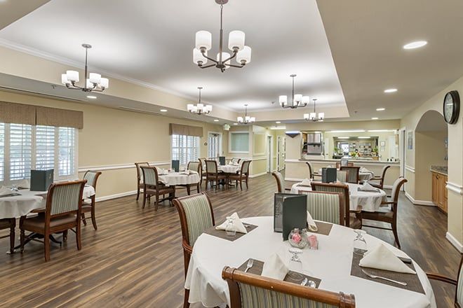 Interior view of Brookdale Spring Shadows senior living community featuring dining area and tech amenities.