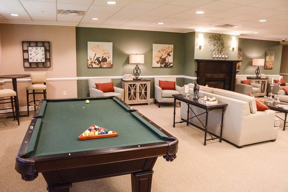 Senior living community, The Chelsea At Warren, featuring a furnished billiard room with pool table.