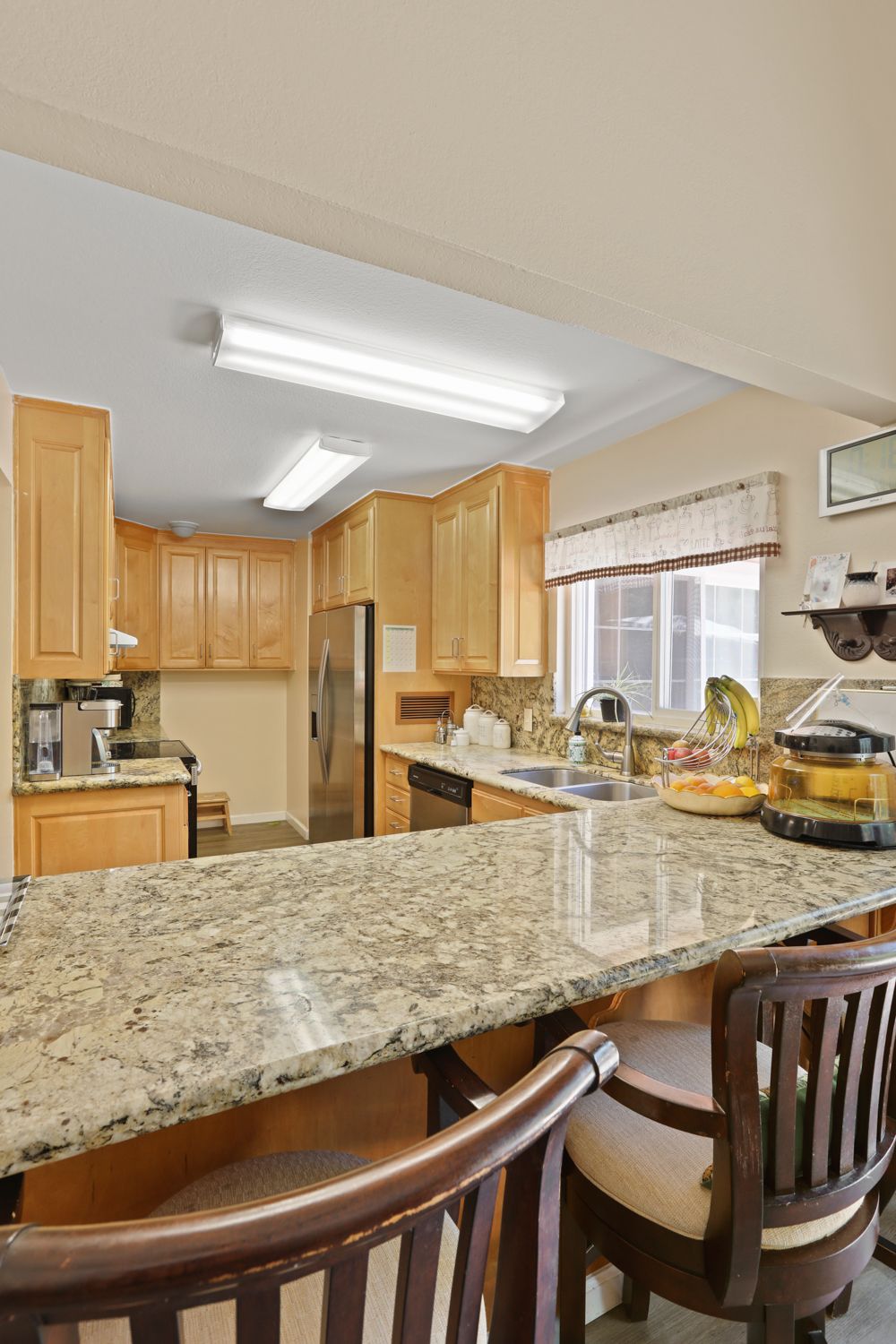 Interior view of Robert Creek Villa senior living community featuring a well-designed kitchen and dining area.