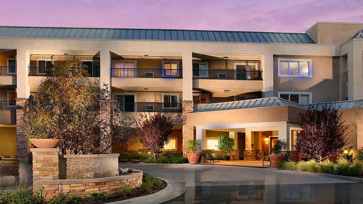 Architectural view of Atria Golden Creek senior living community in an urban city.