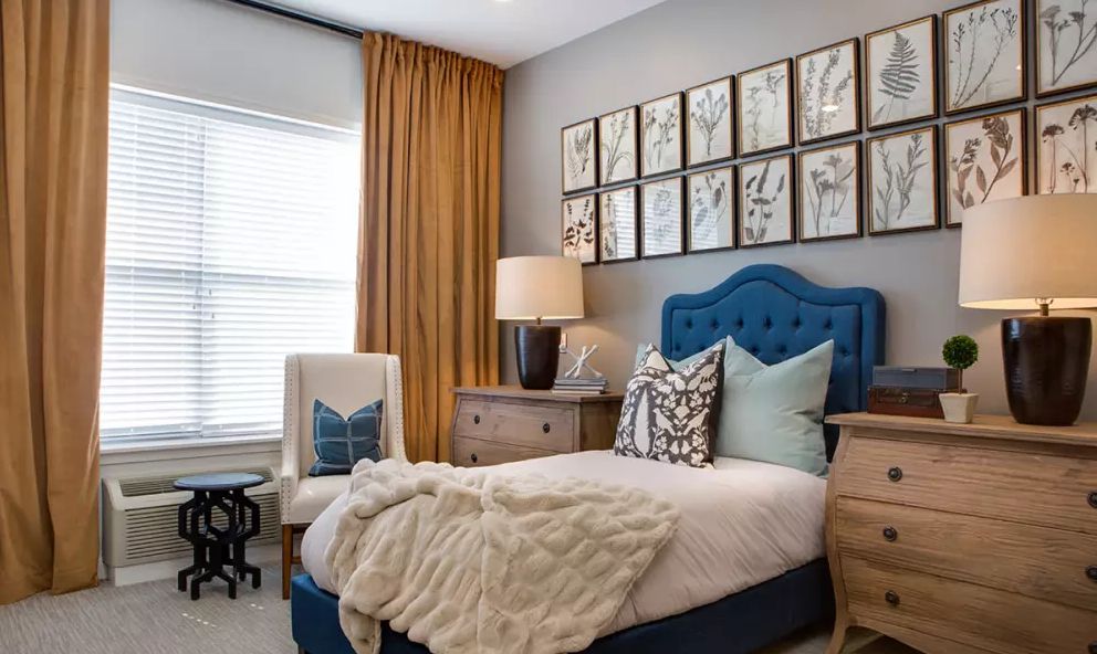 Interior design of a bedroom in Anthology Of Troy senior living community featuring art, furniture, and decor.