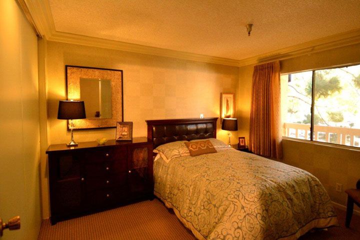 Interior view of a well-furnished bedroom at Huntington Retirement Hotel with elegant home decor.