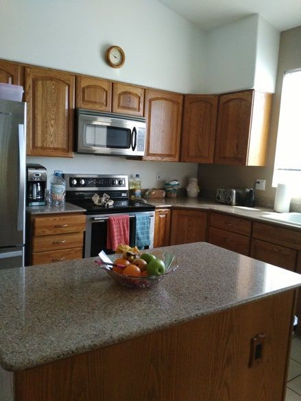 Senior living kitchen at Rhodas Assisted Living Home featuring modern appliances and fresh produce.