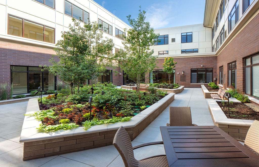 Senior living community, The Sheridan at River Forest, featuring urban architecture, garden, and terrace.