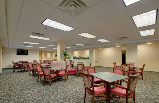 Interior view of Senior Suites Bridgeport featuring dining area, reception room with electronics.