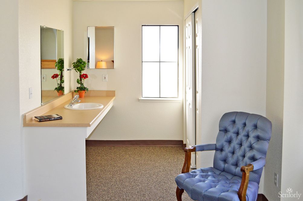 Interior view of Marymount Villa Retirement Center featuring armchairs, flower arrangements, and modern design.