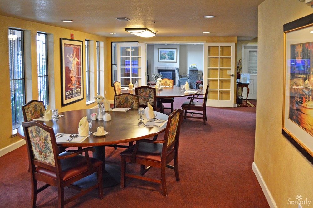 Interior view of Marymount Villa Retirement Center featuring dining room with wooden furniture and decor.
