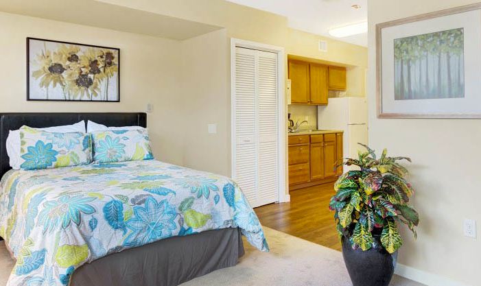 Interior view of a cozy bedroom at Merrill Gardens At Lafayette senior living community.