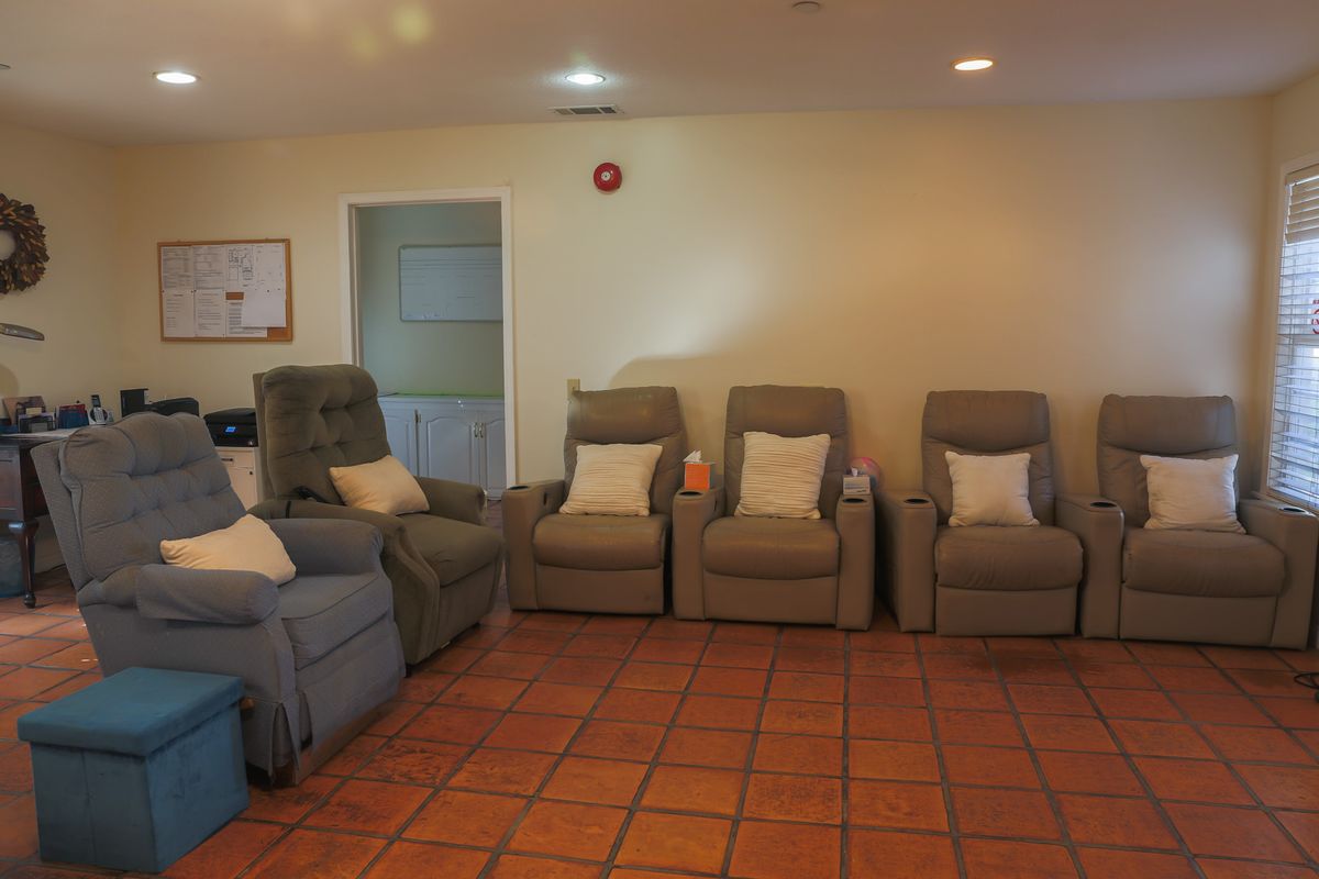 Senior living room interior at Ocean Breeze Estates, featuring modern furniture and flooring.