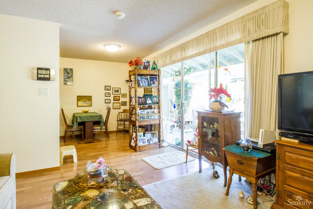 Senior living room at Lincoln Glen Assisted Living Center with modern decor and electronics.