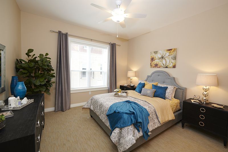 Interior view of a bedroom at Allegro Richmond Heights senior living community.