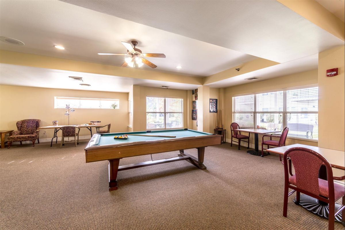 Senior living community, Autumn View Gardens Creve Coeur, showcasing furnished billiard room with pool table.