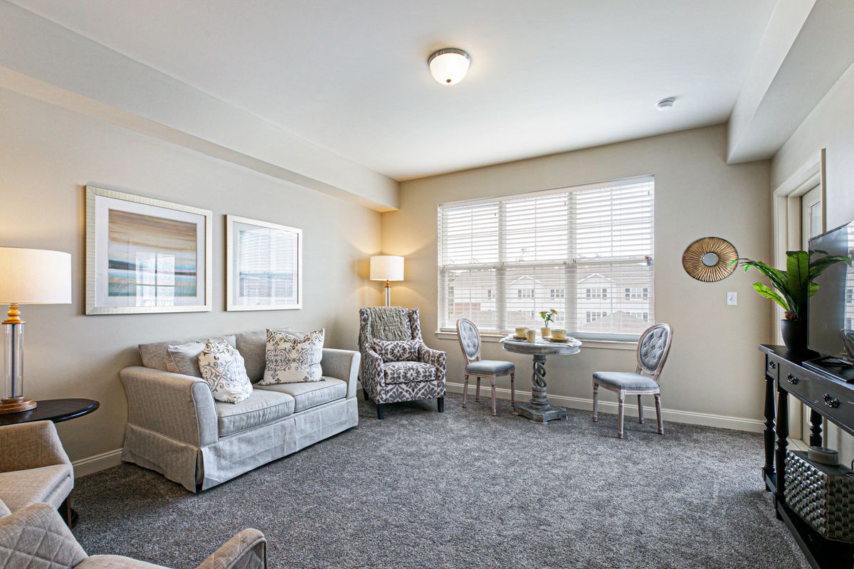 Senior living room interior at St. Anthony's Gardens with modern furniture and decor.
