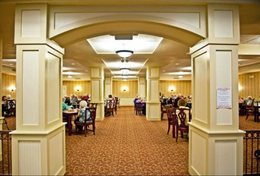 Seniors enjoying a meal in the well-furnished dining room at Primrose Retirement Community, Kansas City.