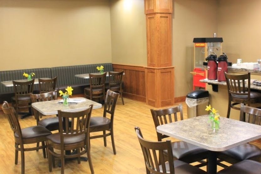 Interior view of Primrose Retirement Community in Kansas City featuring dining area with wooden furniture.