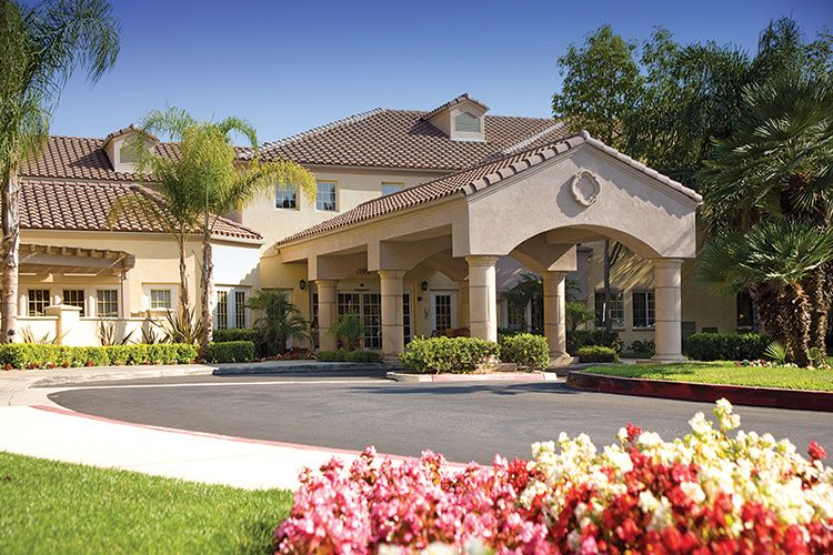 Senior living community, Park Terrace, featuring villas, lush gardens, and residents outdoors.