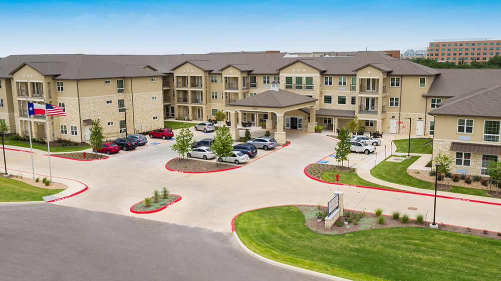 Aerial view of The Enclave at Round Rock Senior Living community with urban architecture.