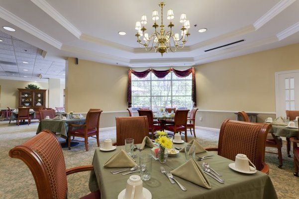Interior view of Brighton Gardens senior living community featuring dining room with elegant decor.