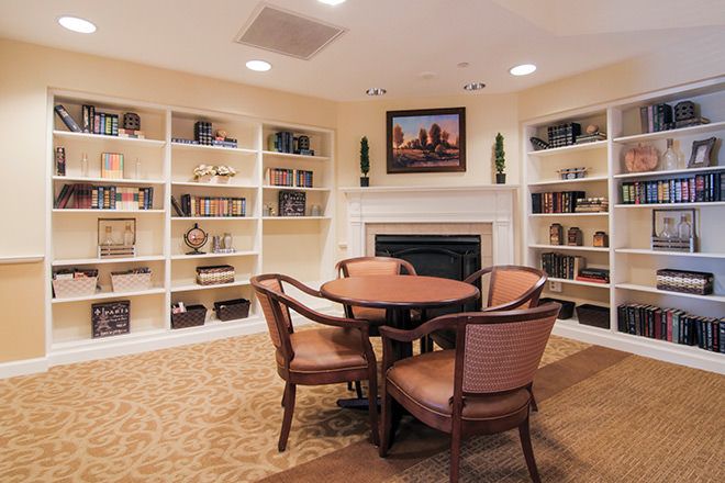 Senior living community Brookdale Lake Ridge featuring dining room with table, chairs, bookcase and decor.