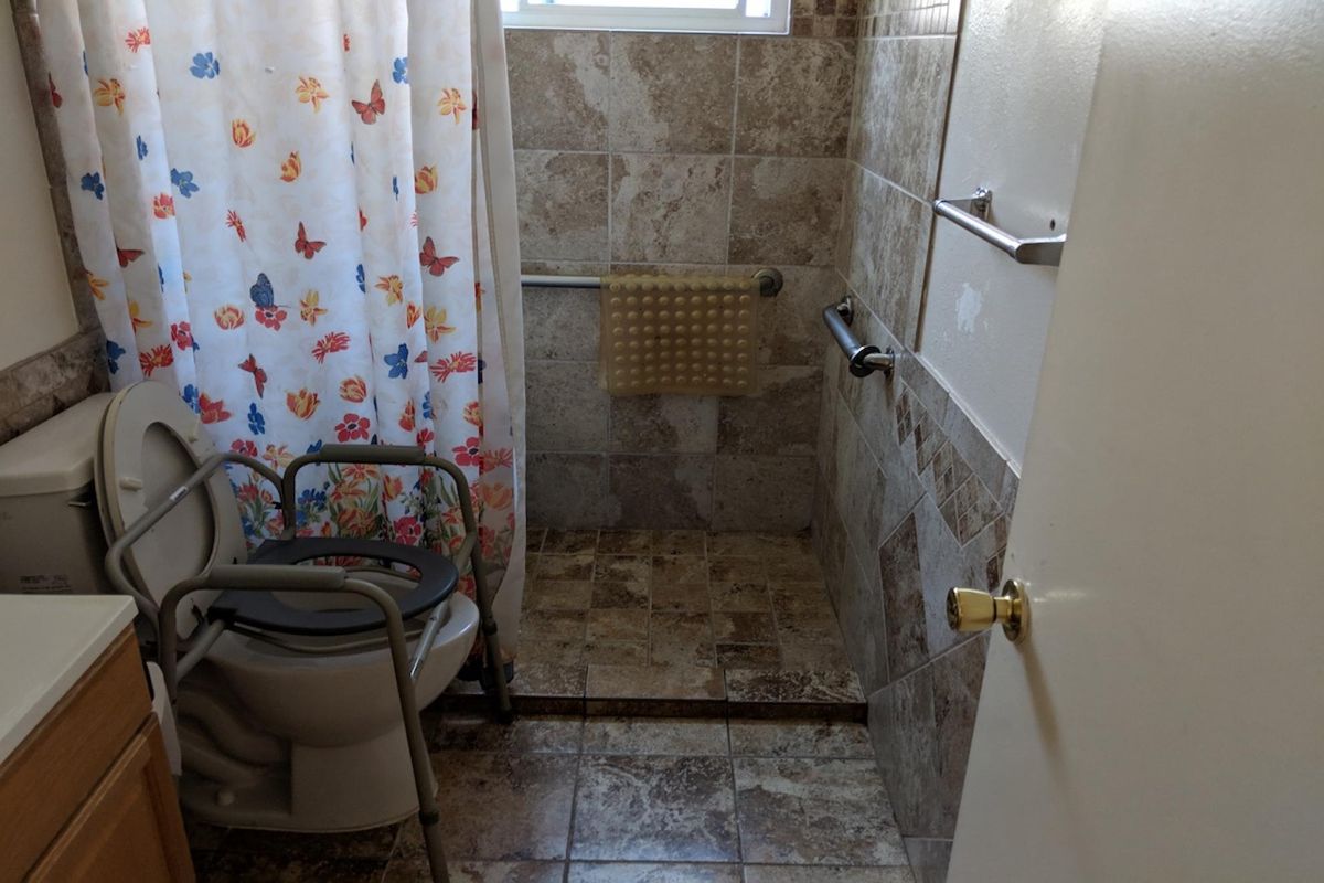 Interior view of a room with bathroom facilities at Angel Genesis Senior Living Home.