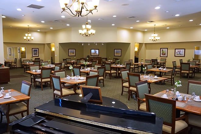 Interior view of Brookdale Midland senior living community featuring dining area, art, and electronics.