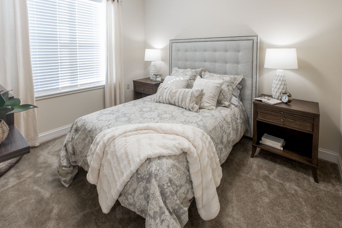 Cozy bedroom interior at The Princeton Senior Living with comfortable bed and home decor.