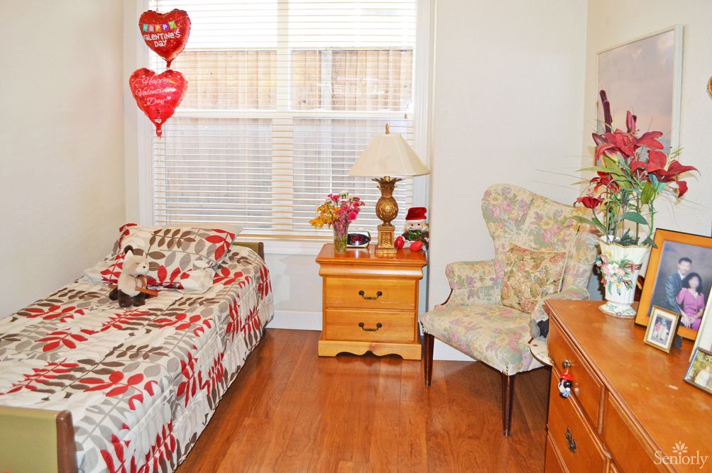 Senior living room interior at Lifeshare Care Home 3 with hardwood flooring and cozy decor.