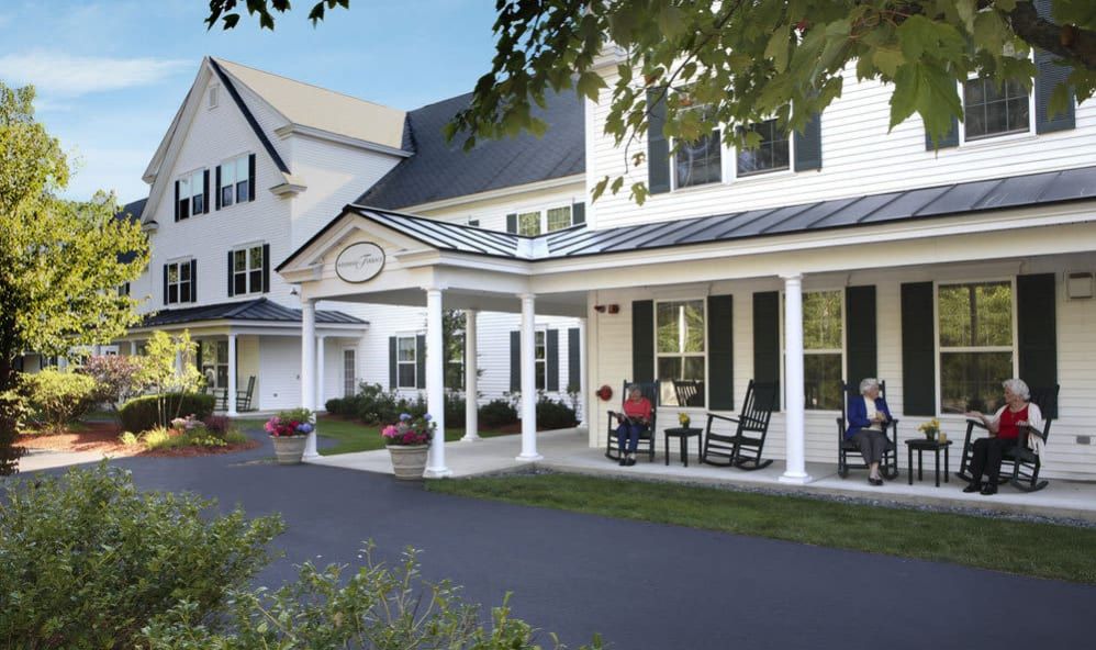 Senior living community, Windham Terrace, featuring housing architecture, furniture, and lush greenery.