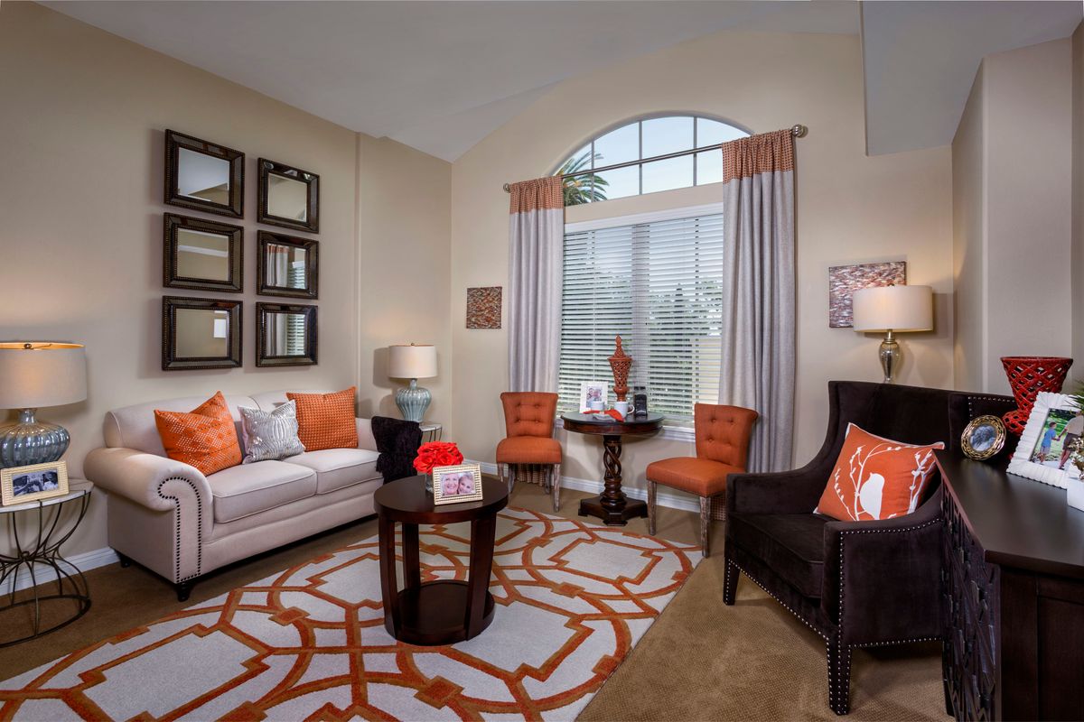 Senior enjoying a beautifully decorated living room with modern furniture at The Kensington Sierra Madre.