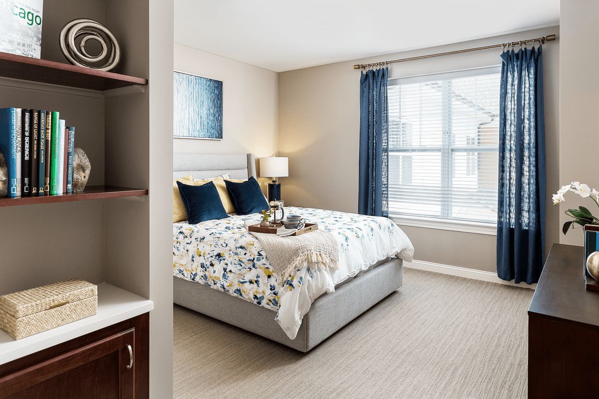 Interior view of a cozy bedroom with elegant decor and furniture at Arbor Terrace Glenview senior living.