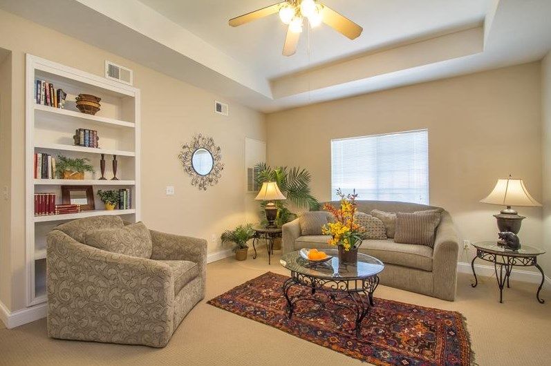 Senior living room at Carnegie Village with cozy decor, furniture and modern appliances.