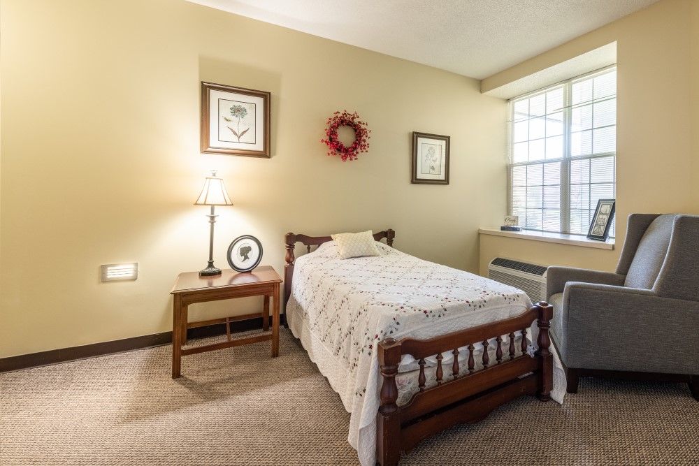 Interior view of a bedroom in American House Johnson City senior living community, featuring modern decor.