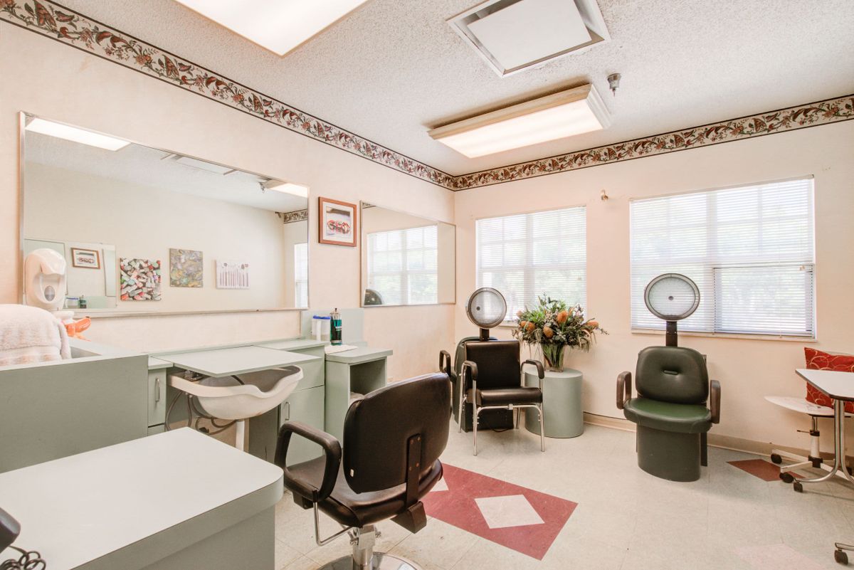 Senior living community Truewood By Merrill in Venice, featuring a beauty salon with chairs and furniture.